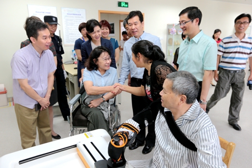 图为海迪主席与伤残患者家属亲切交谈